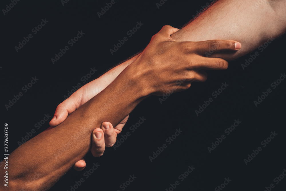 Black lives matter. Racial friendship. Multicolor male hands holding together isolated on dark copy space. Ethnic tolerance. No racism. Peace support