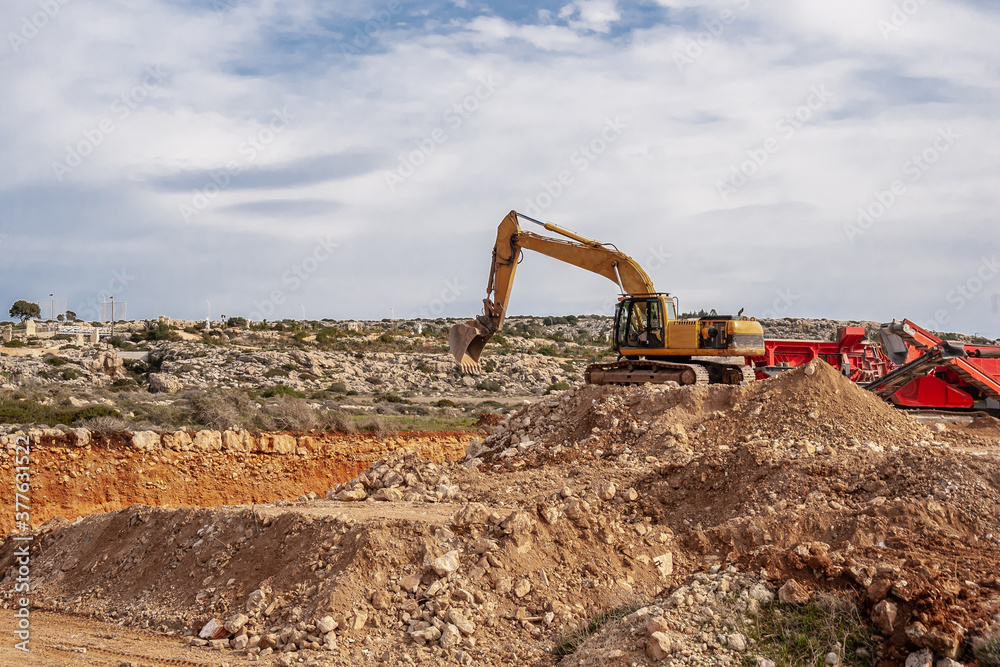Excavator extracts stone in a quarry Excavator extracts stone in a quarry