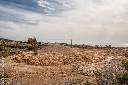 Excavator extracts stone in a quarry.