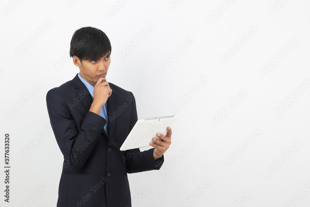 Young handsome asian business man using tablet computer with smiling isolated on white background. Young handsome asian business man using tablet computer with smiling isolated on white background.