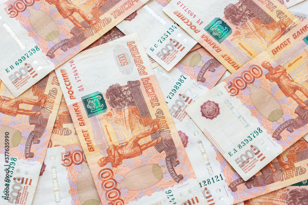 Five-thousandth Russian bills lie chaotically on the table Five-thousandth Russian bills lie chaotically on the table
