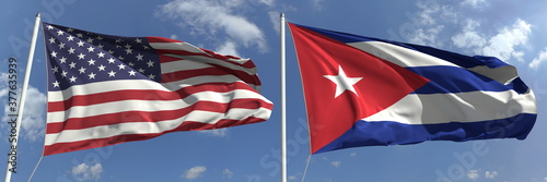 Flying flags of the United States and Cuba on high flagpoles. 3d rendering