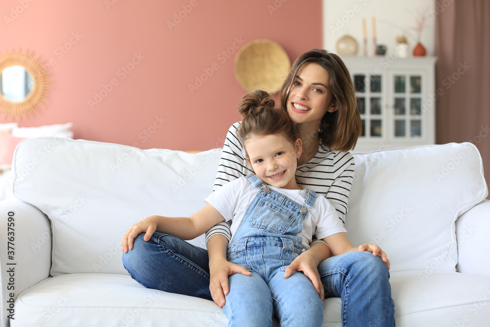 Happy loving mom hugging little daughter, spend time together at home. Happy loving mom hugging little daughter, spend time together at home.
