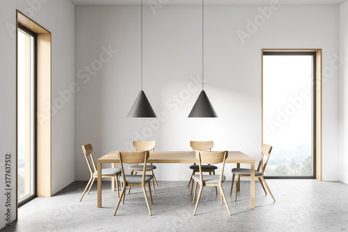 White dining room interior with wooden table