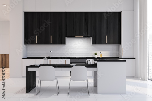White and black kitchen with bar