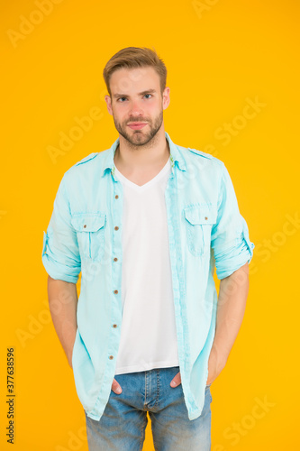 stylish unshaven guy wear casual shirt on yellow background, male fashion