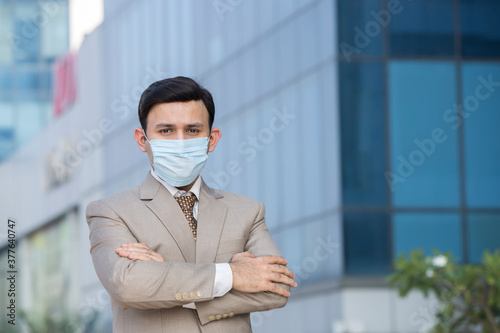 Businessman with protective face mask in city
