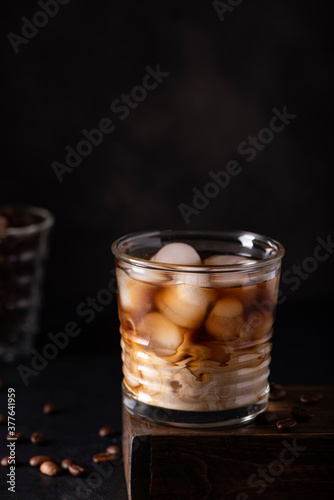 black ice coffee with milk in a glass