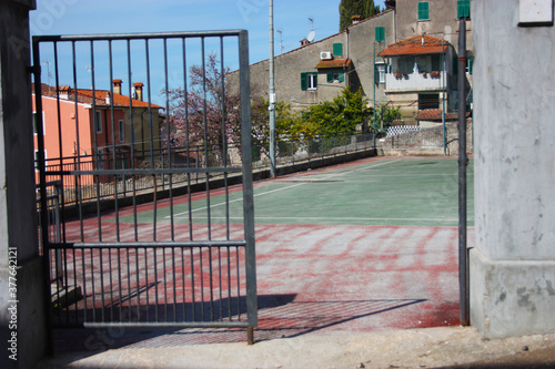 the iron gate of access for the soccer field of the country © Alessia