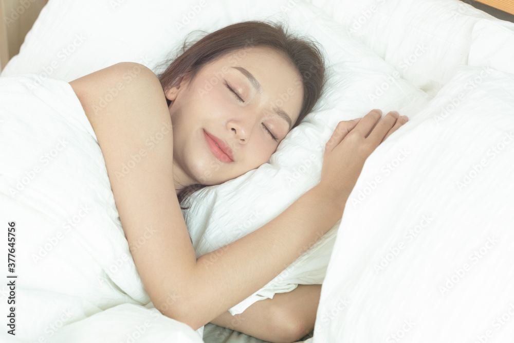 Asian women sleeping and sweet dream on white bed in bedroom Asian women sleeping and sweet dream on white bed in bedroom