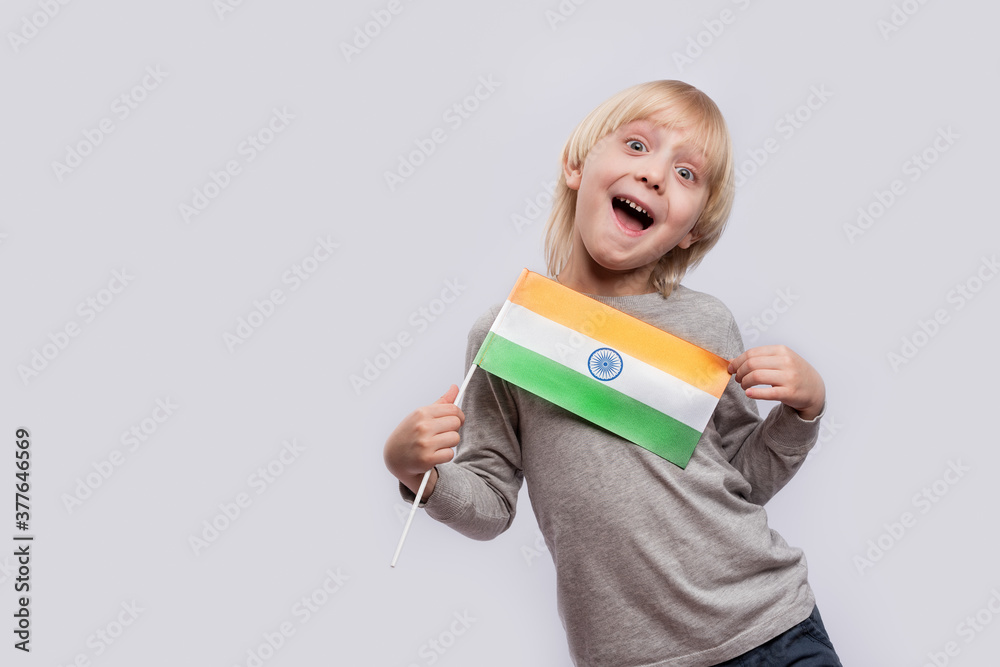 Happy boy holding flag of India and makes funny faces. Learning hindi Happy boy holding flag of India and makes funny faces. Learning hindi
