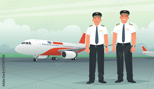 Two pilots on the background of a passenger aircraft at the airport. Ship captain and co-pilot, airline employees