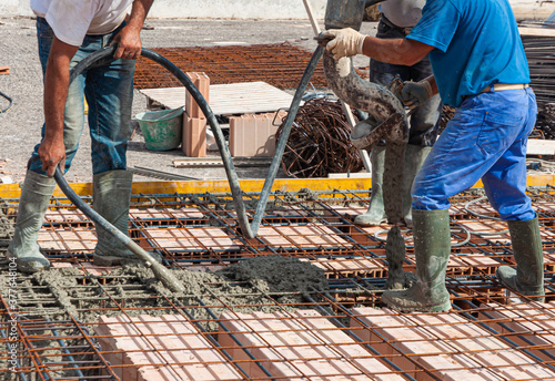 pouring concrete slab - concrete pouring during commercial concreting floors of buildings in construction