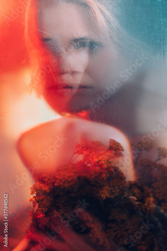Art portrait. Fantasy dream. Double exposure defocused silhouette of tender woman face flowers in red blue bokeh light with old film dust scratches stains effect. Nature inspiration.