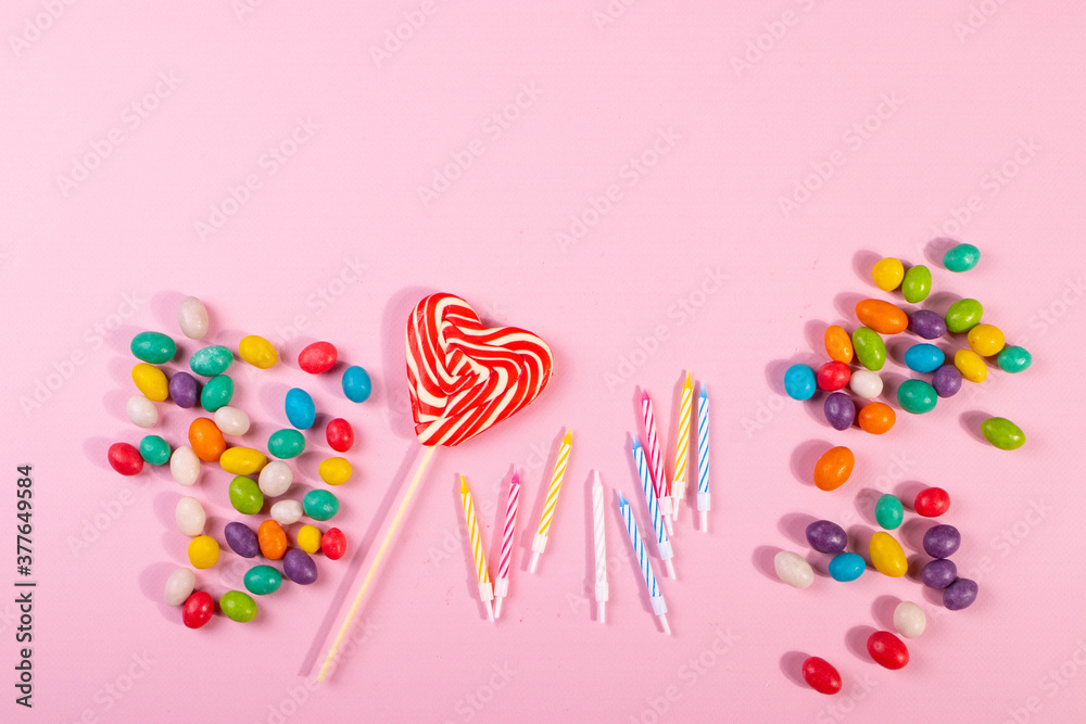 sweet bright colour candies on pink