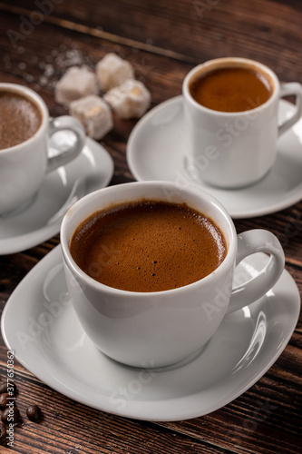 Traditional Greek - Turkish Coffee cup and Turkish delight concept with wooden background