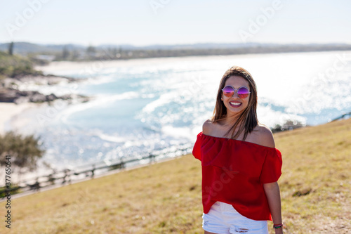 A beautiful girl walking on the high hill over the seashore