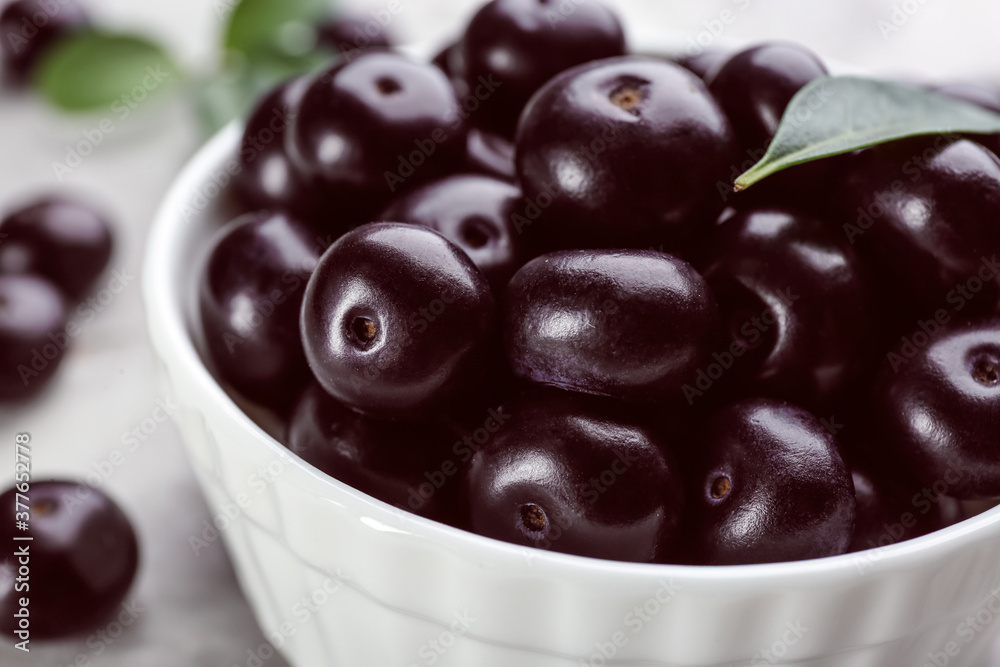 Fresh acai berries in bowl, closeup view Fresh acai berries in bowl, closeup view