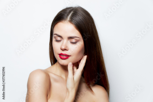 Woman Red lips closed eyes bared shoulders cropped view spa treatments 