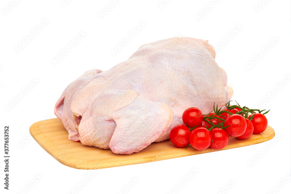 Fresh raw chicken carcass on a wooden cutting Board with vegetables and herbs, on a white background.
