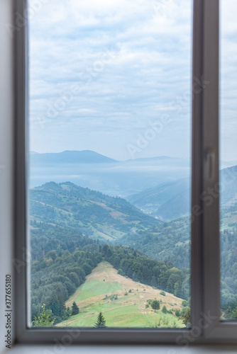 Mountain landscape in the window. Mountain view through the window.