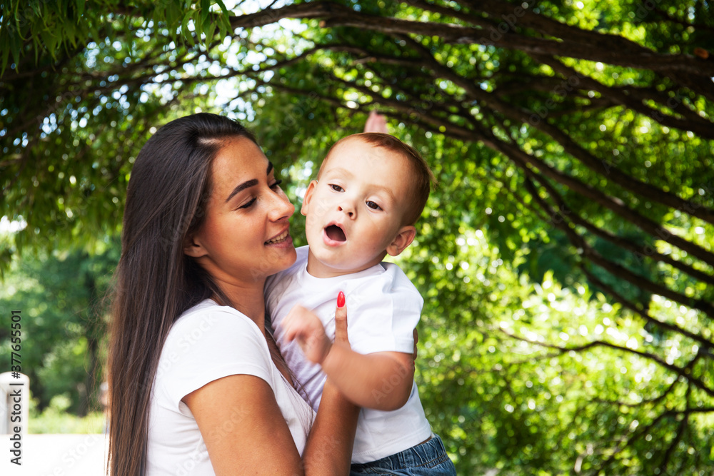 young pretty brunette mother with little cute boy walking in park happy smiling, lifestyle people concept young pretty brunette mother with little cute boy walking in park happy smiling, lifestyle people concept