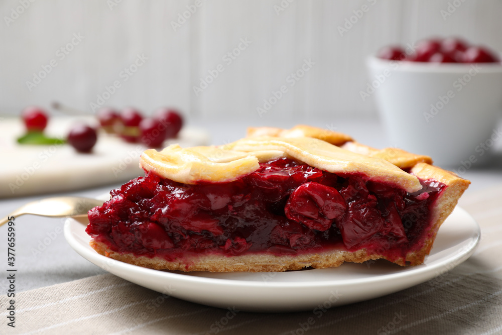 Slice of delicious fresh cherry pie on table, closeup Slice of delicious fresh cherry pie on table, closeup