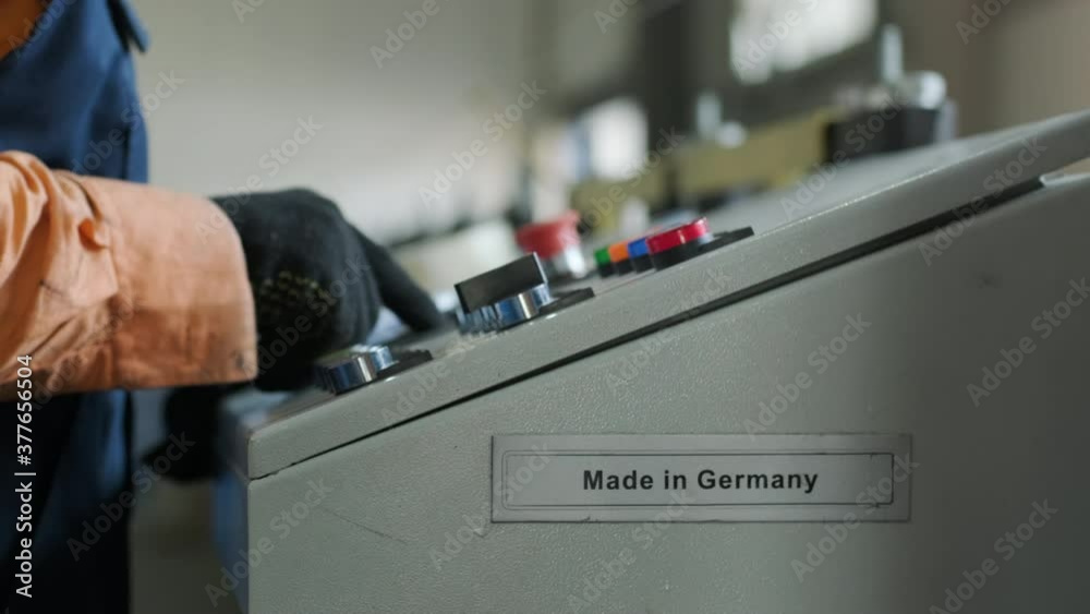 man working on the control panel works with an industrial machine at the factory close-up. man working on the control panel works with an industrial machine at the factory close-up.