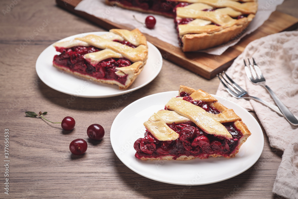 Slices of delicious fresh cherry pie served on wooden table, closeup Slices of delicious fresh cherry pie served on wooden table, closeup