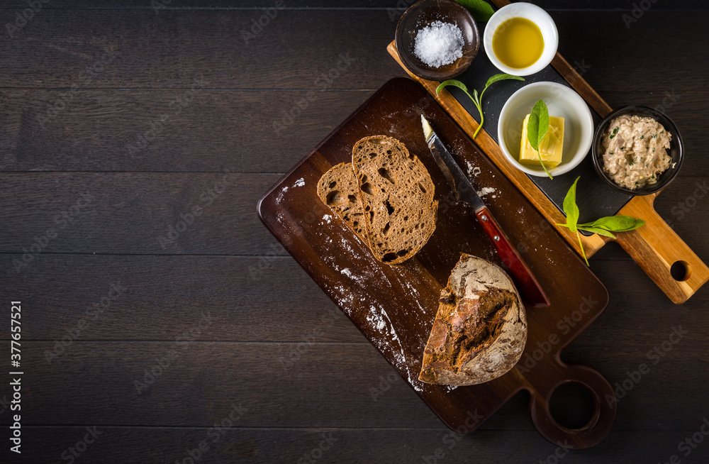 Tuna spread with fresh bread slice, sage butter, olive oil and salt on rustic wooden table Tuna spread with fresh bread slice, sage butter, olive oil and salt on rustic wooden table