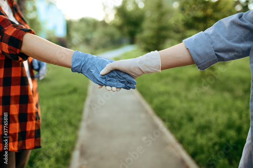 Love couple in gloves walks in park, quarantine