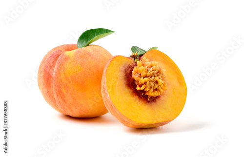 Fresh sweet sliced peach with green leaf isolated on white background.