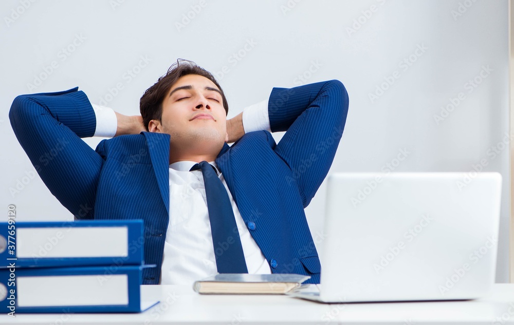 Young handsome businessman employee working in office at desk Young handsome businessman employee working in office at desk