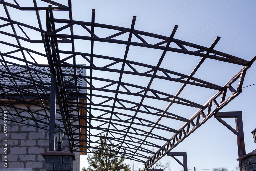 Workers are installing a metal canopy.