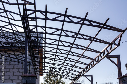 Workers are installing a metal canopy.