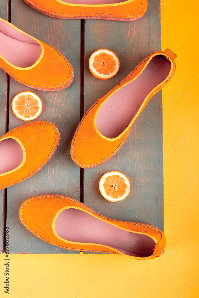 Fototapeta premium Yellow espadrilles shoes near slices of lemon
