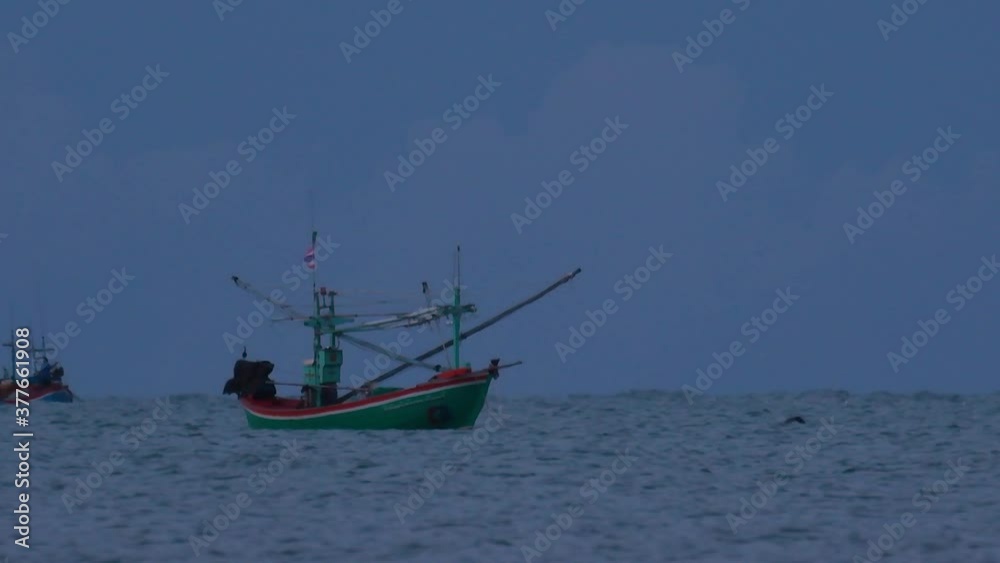Fishing Boats in Thailand wait in the middle of the ocean for dark to come so they can turn on their green lights and start fishing and troll for shrimps. Fishing Boats in Thailand wait in the middle of the ocean for dark to come so they can turn on their green lights and start fishing and troll for shrimps.
