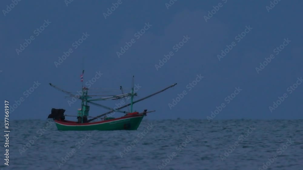 Fishing Boats in Thailand wait in the middle of the ocean for dark to come so they can turn on their green lights and start fishing and troll for shrimps. Fishing Boats in Thailand wait in the middle of the ocean for dark to come so they can turn on their green lights and start fishing and troll for shrimps.