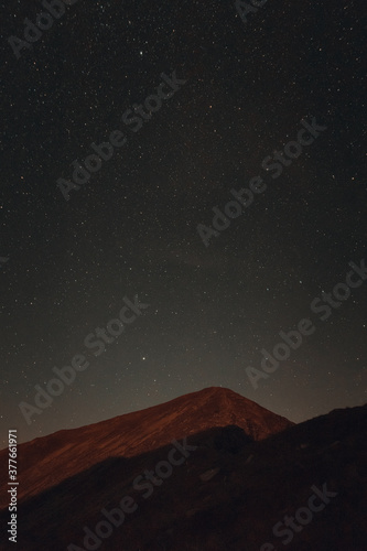 Mountain peak landscape in the night with stars above © Mihai