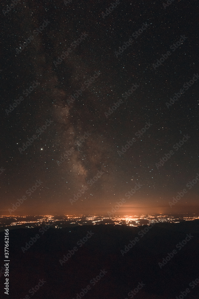 Milky way galaxy and the city from the mountain Milky way galaxy and the city from the mountain