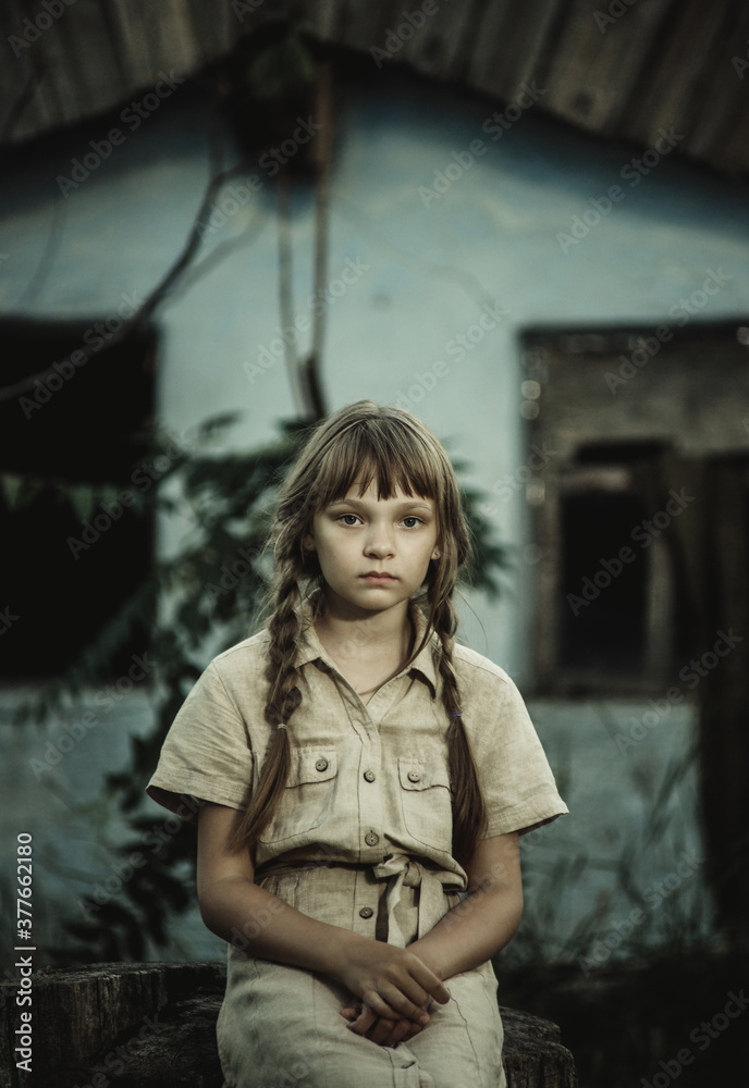 sad teenage girl sitting by an abandoned building sad teenage girl sitting by an abandoned building