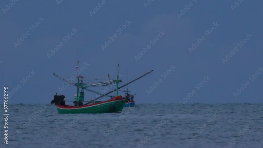 Fishing Boats in Thailand wait in the middle of the ocean for dark to come so they can turn on their green lights and start fishing and troll for shrimps. Fishing Boats in Thailand wait in the middle of the ocean for dark to come so they can turn on their green lights and start fishing and troll for shrimps.
