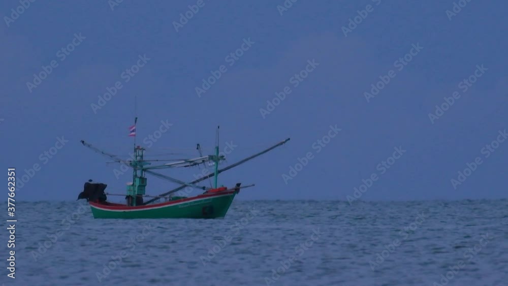 Fishing Boats in Thailand wait in the middle of the ocean for dark to come so they can turn on their green lights and start fishing and troll for shrimps. Fishing Boats in Thailand wait in the middle of the ocean for dark to come so they can turn on their green lights and start fishing and troll for shrimps.