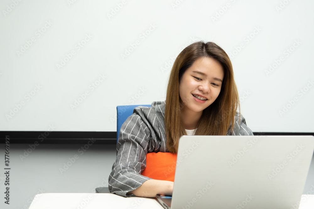 Woman working by laptop in office with happy Woman working by laptop in office with happy
