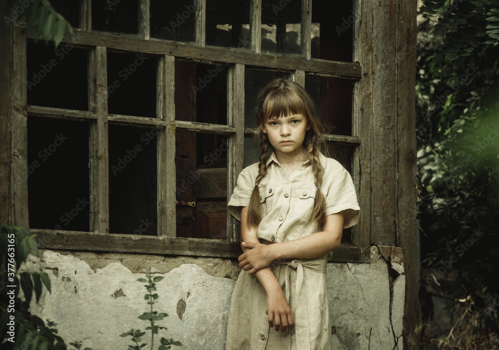 teenage girl on the background of an old wooden window