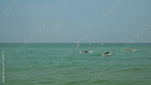 Korean people surfing on dead calm weather, studing surfing on surfyy beach in Seokcho area, Yangyang area, South Korea photo