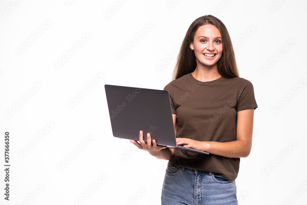 Young smiling confident woman using laptop computer and looking camera isolated over white background Young smiling confident woman using laptop computer and looking camera isolated over white background
