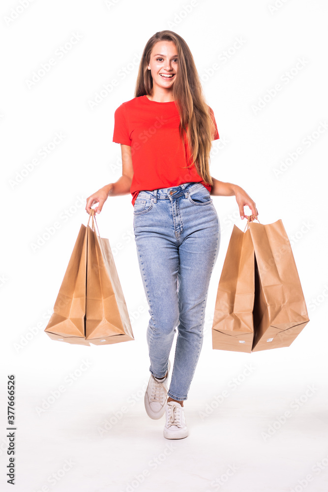 Portrait of young happy smiling woman with shopping bags over white background Portrait of young happy smiling woman with shopping bags over white background