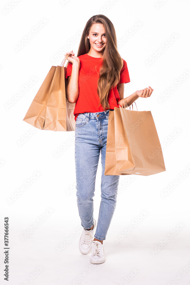 Portrait of young happy smiling woman with shopping bags over white background