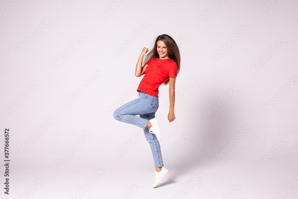 Beautiful young jumping girl isolated on white background